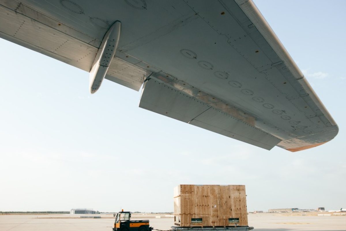Picture of a truck pulling a cargo box in an airport runway
